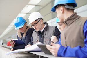 Construction manager giving instructions to training students